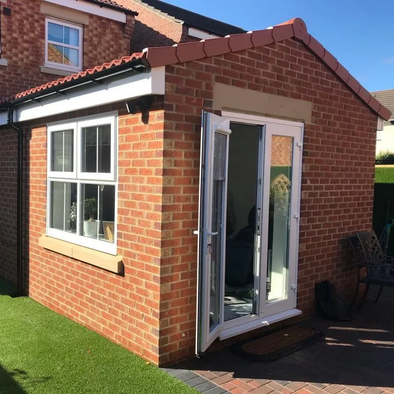 A small brick house with a sliding glass door.